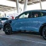 Blue Ford Mustang Mach-E EV SUV Tesla Charging Station