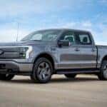 Gray Ford F-150 Lightning Pickup Truck EV Blue Sky Road