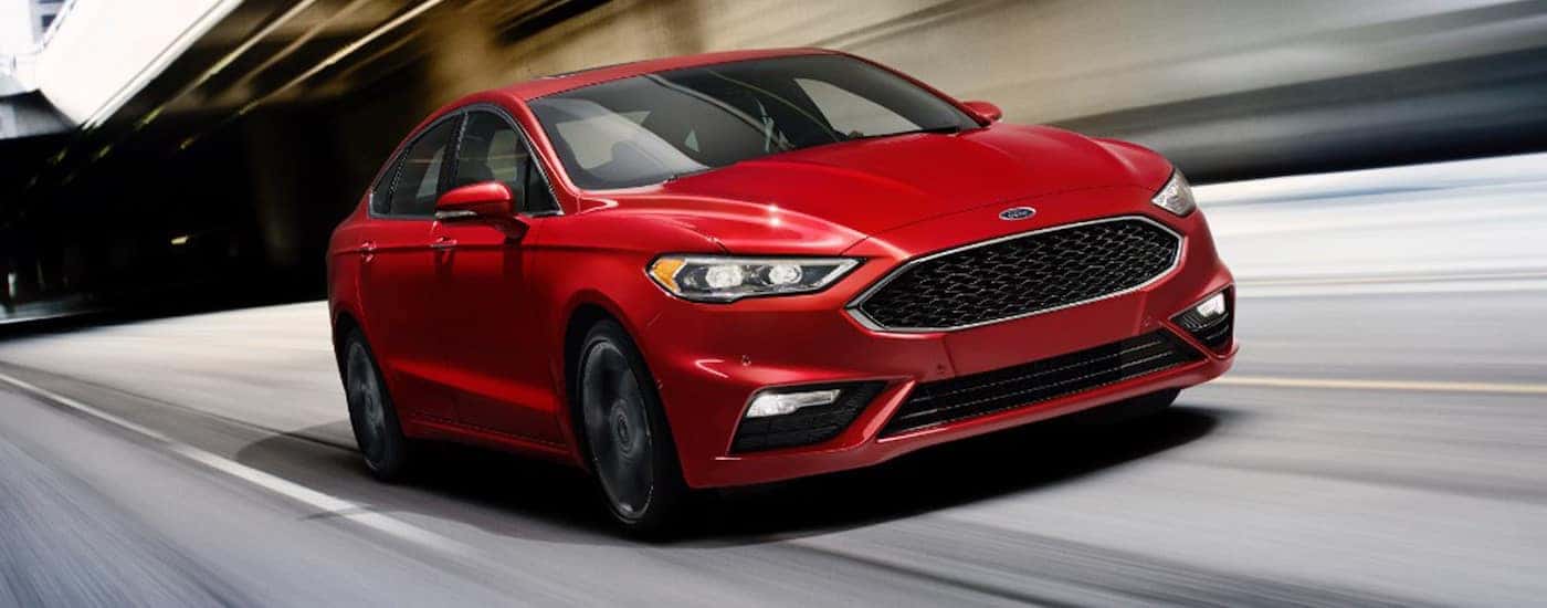 2018 Ford Fusion in Red Driving on the Road