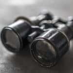 Black and white photo of binoculars sitting near the edge of a table