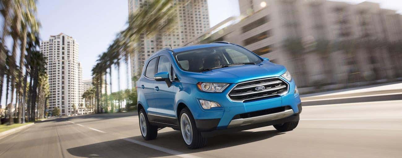 A light blue 2019 Ford EcoSport cruises down a city street