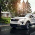 White 2019 Ford Explorer driving through suburb