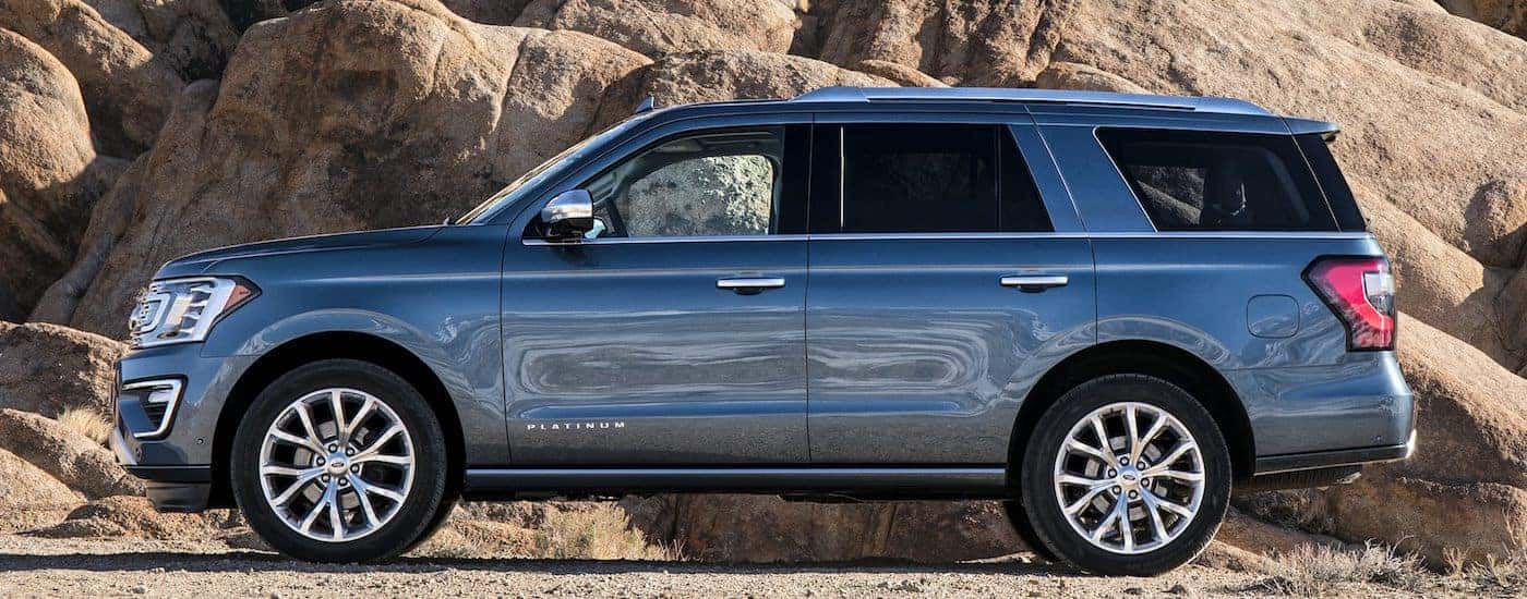 Blue 2019 Ford Expedition Platinum parked against cliff