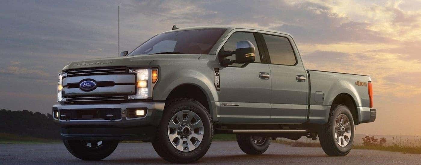 A gray 2019 Ford F-250 at the ocean at sunset