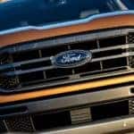 A closeup of the grille on a new orange 2019 Ford Ranger