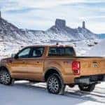 An orange 2020 Ford Ranger among snow-covered mountains