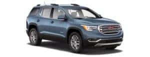 A blue 2019 GMC Acadia is facing right.