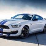 A blue and white 2017 Ford Mustang is surrounded by mist.