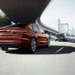 A brown 2019 Ford Fusion, one of the discontinued models as of 2020, is driving under an overpass near Cincinnati, OH.