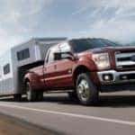 A red 2017 Ford Super Duty is towing a trailer on a highway outside Cincinnati, OH.