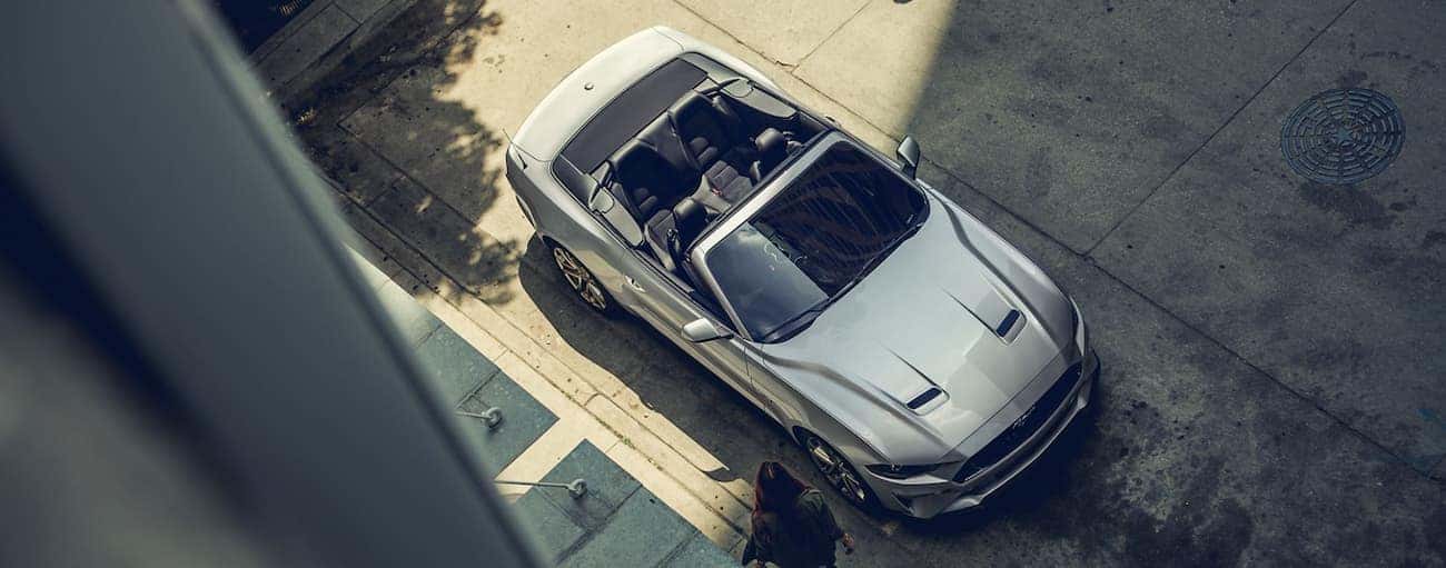 A silver 2020 Ford Mustang convertible is shown from above on a Cincinnati, OH street.