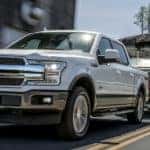 A white 2020 Ford F-150 is towing a large boat near Cincinnati, OH.