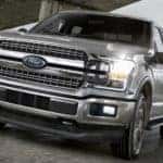 A silver 2020 Ford F-150 Lariat is drivin gon a highway near Cincinnati, OH.