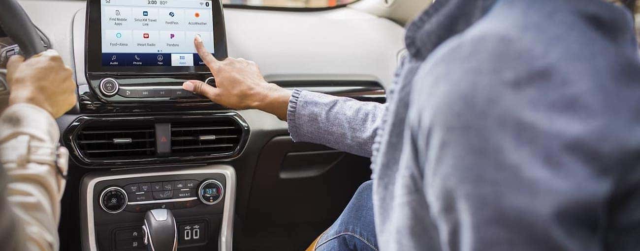 A passenger is using the touchscreen in a 2020 Ford EcoSport.