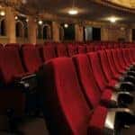 Red rows of seats are shown in a theatre.