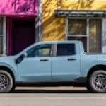 A light blue 2022 Ford Mavereick is shown from the side parked on a city street.