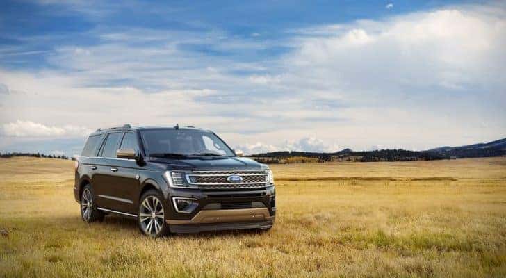 A black 2021 Ford Expedition King Ranch is shown parked in a field.