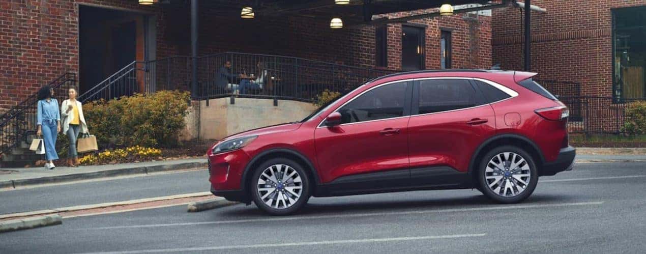 A red 2022 Ford Escape is shown from the side parked in front of a brick building.