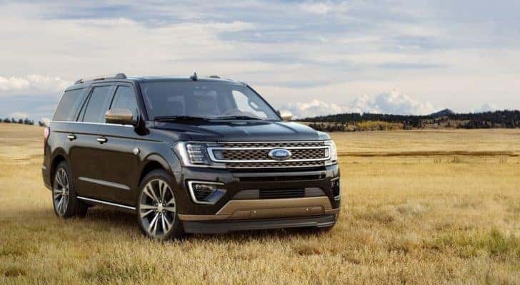 A black 2020 Ford Expedition is shown parked in a dry grassy field after leaving a certified pre-owned Ford dealer.
