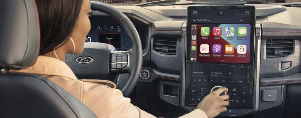 The black interior of a 2023 Ford Expedition shows the steering wheel and infotainment screen.