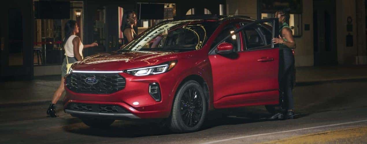 A red 2023 Ford Escape is shown parked on a city street.