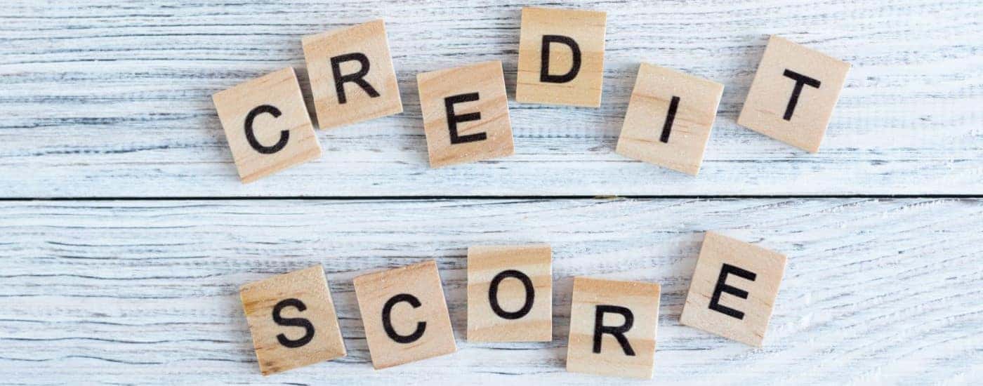 A close up shows blocks that spell credit score.