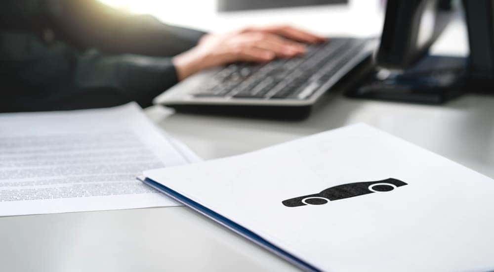 A set of paperwork is shown on a desk after researching how to 'value my trade.'