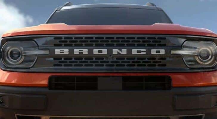 A close up shows the grille on an orange 2023 Ford Bronco Sport Badlands.