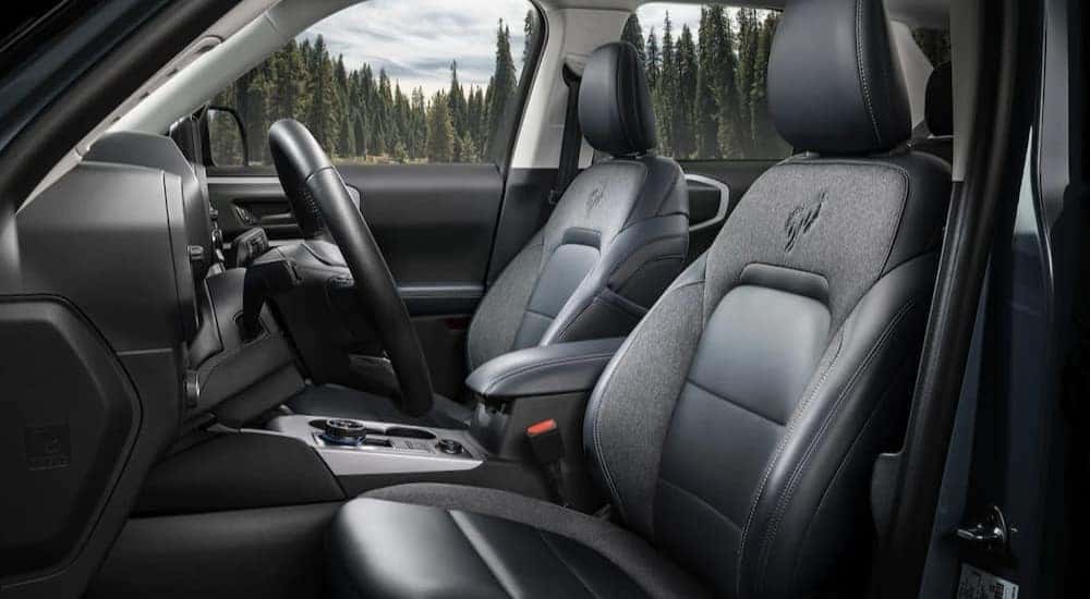 The black and gray interior of a 2023 Ford Bronco Sport for sale is shown.