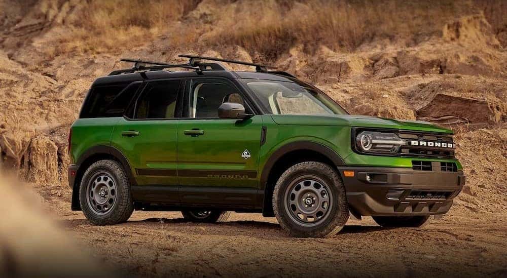 A green 2023 Ford Bronco Sport Outer Banks is shown parked off-road.