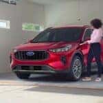 One of man popular Ford hybrid models, a red 2023 Ford Escape Hybrid, is shown parked in a garage.