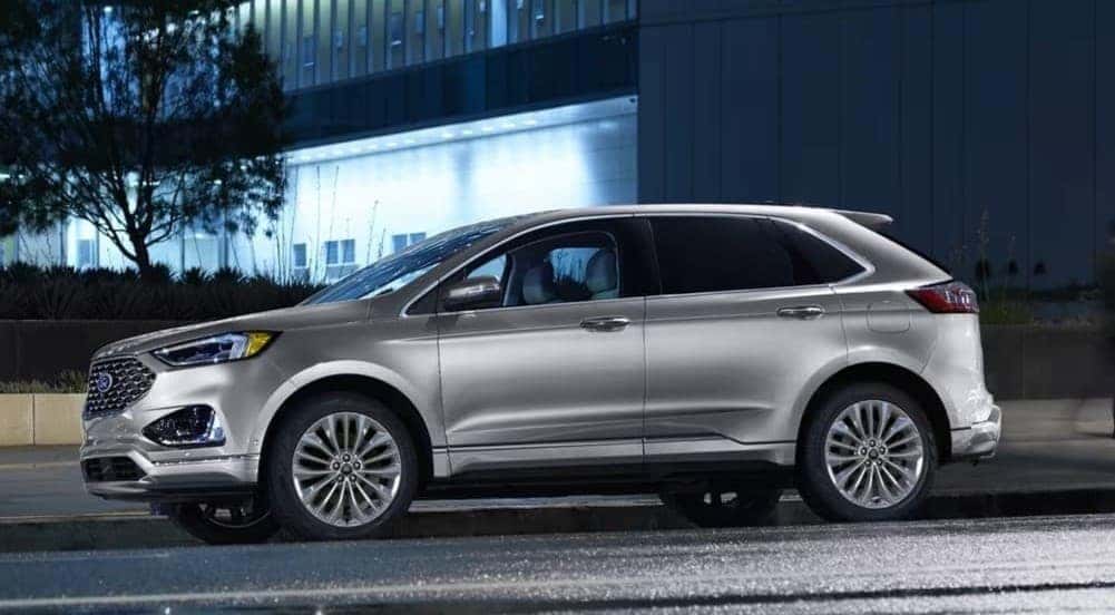 A silver 2024 Ford Edge is shown parked on a city street.