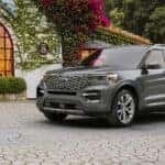 A silver 2024 Ford Explorer Premium parked on a garden patio.