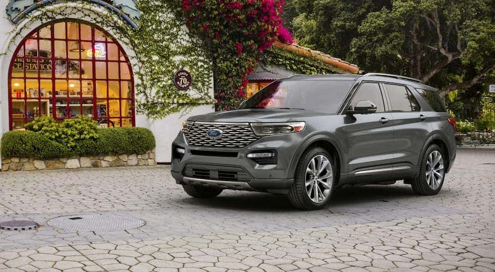 A silver 2024 Ford Explorer Premium parked on a garden patio.