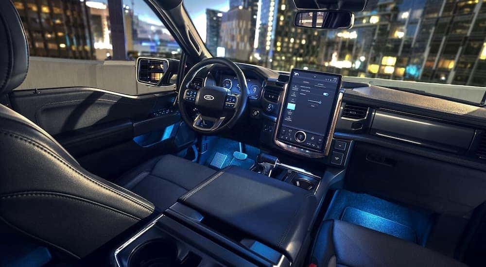 Blue ambient lighting inside the cabin of a 2024 Ford F-150 Lightning, one of many Ford EVs.