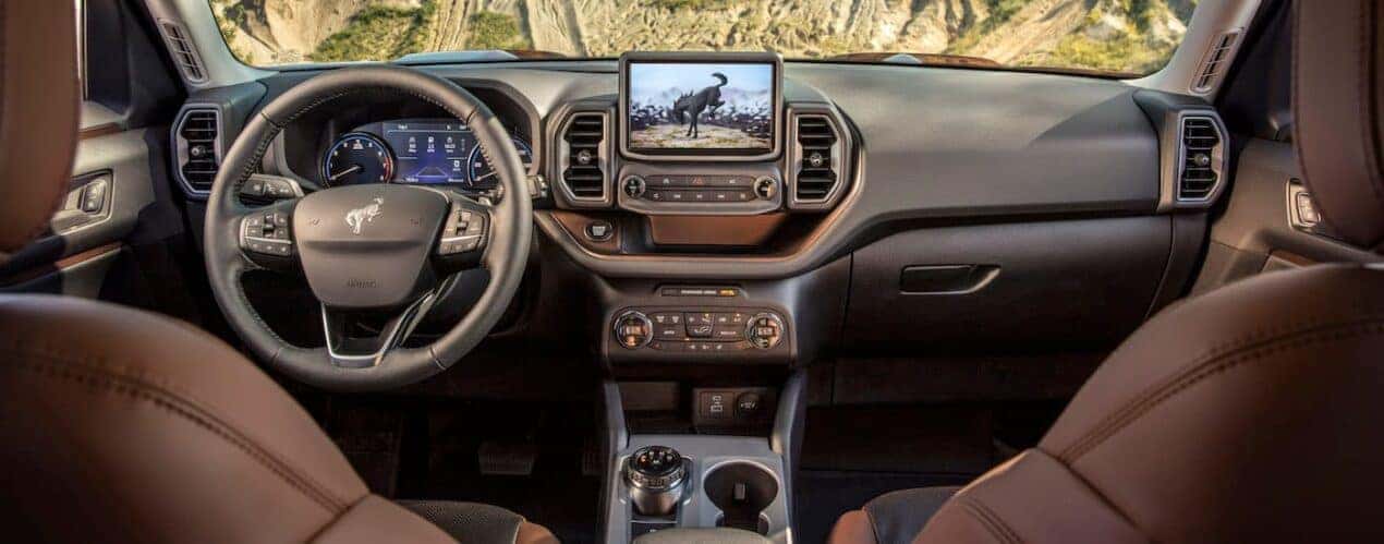 The brown interior of a 2024 Ford Bronco Sport is shown from behind the front seats.