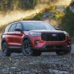 A red 2025 Ford Explorer parked off-road.