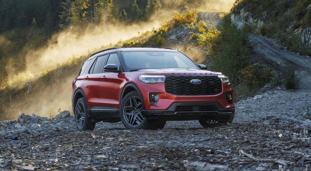 A red 2025 Ford Explorer parked off-road.