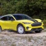 A yellow 2024 Ford Mustang Mach-E Rally is shown from the front at an angle.