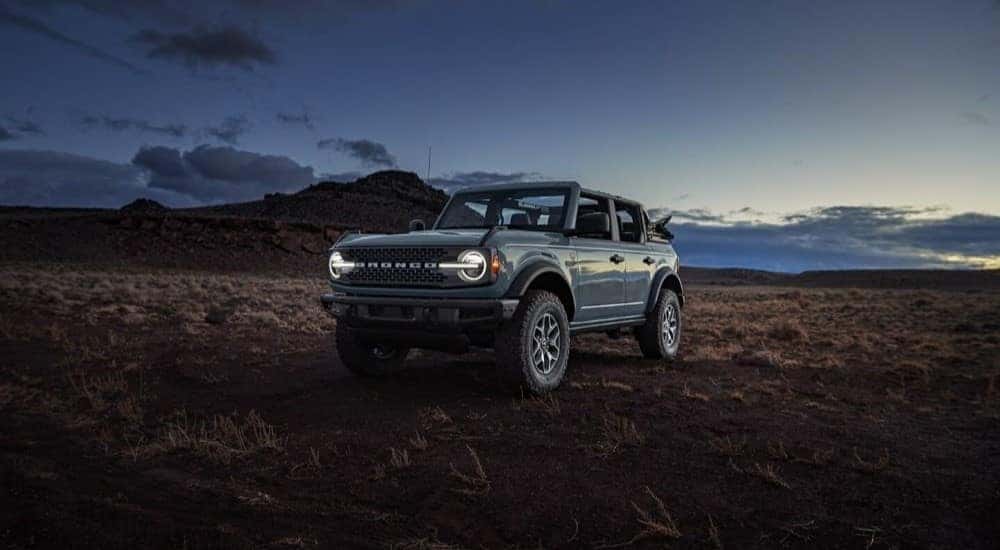 A grey 2024 Ford Bronco Badlands in a field.