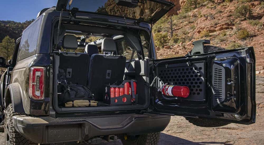 A 2024 Ford Bronco parked off-road with the tailgate open.