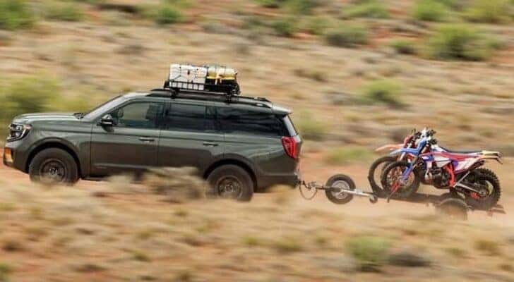 A green 2025 Ford Expedition Tremor is shown driving off-road.