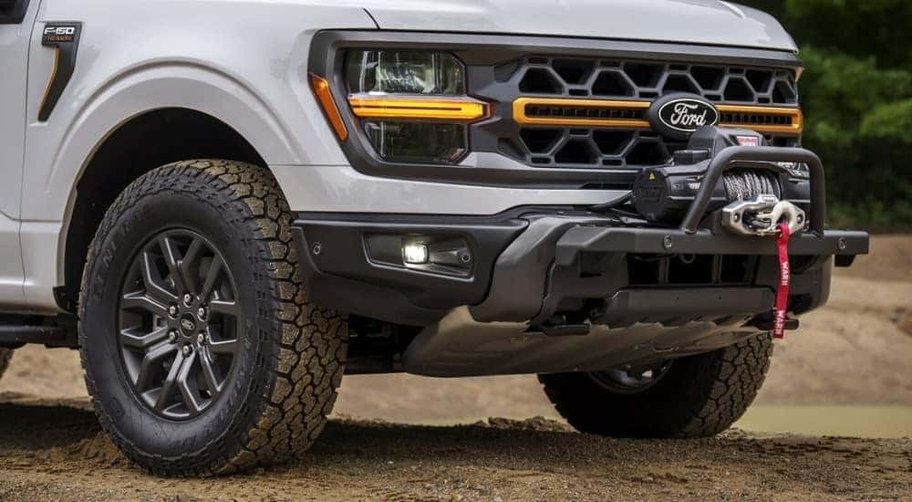 A close up shows the winch on a white  2025 Ford F-150 Tremor.