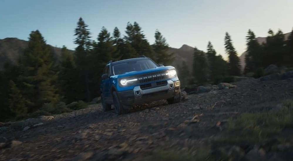 A blue 2025 Ford Bronco Sport Badlands is shown parked off-road.