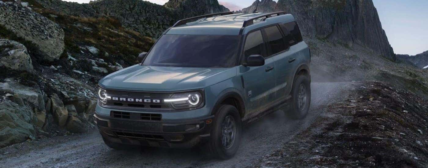 A dark grey 2024 Ford Bronco Sport Big Bend driving down a hill.