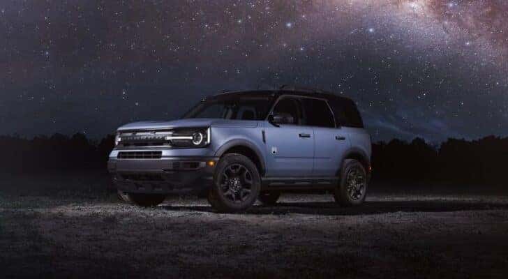 A blue 2024 Ford Bronco Sport Big Bend parked off-road and angled left.