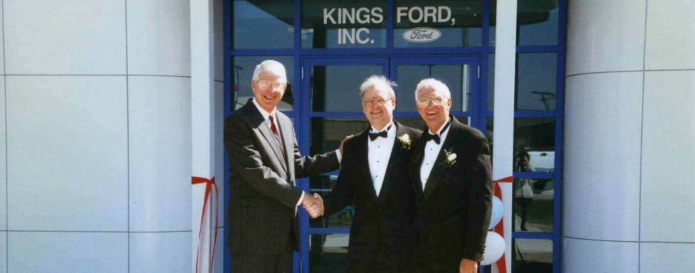 People are shown shaking hands at the Kings Ford grand opening.