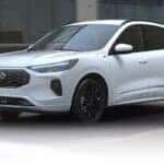 A white 2025 Ford Escape ST-Line Elite is shown driving after viewing a Ford Escape for sale in Cincinnati.