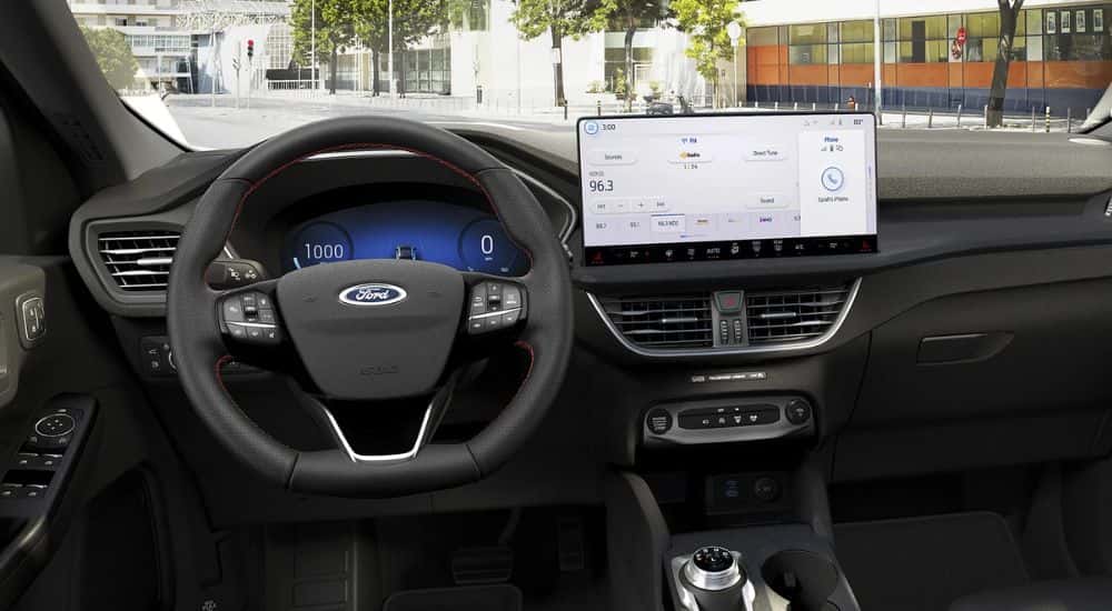 The steering wheel and infotainment screen in a 2025 Ford Escape for sale in Cincinnati.