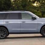 A blue 2025 Ford Expedition is shown parked on a driveway.
